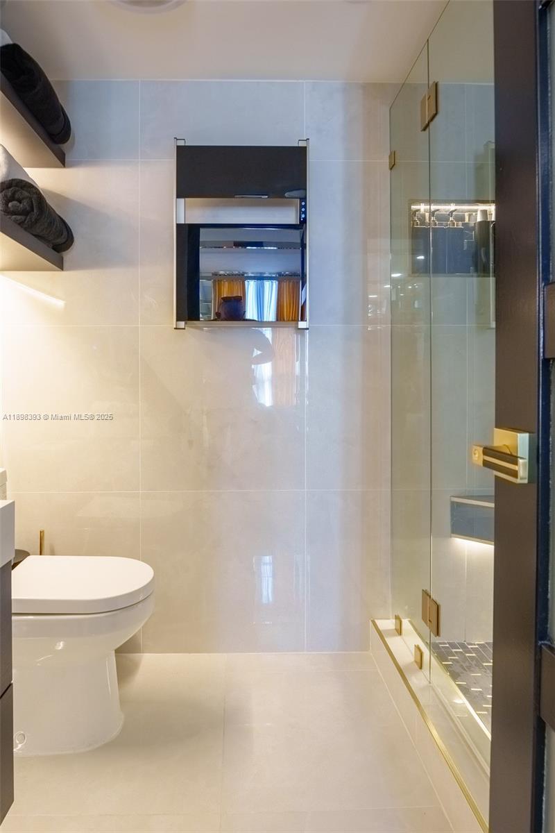 4000 Towerside Terrace, Unit 410 Miami, FL 33138 - Photo 24 of 74 a bathroom with a toilet and a shower
