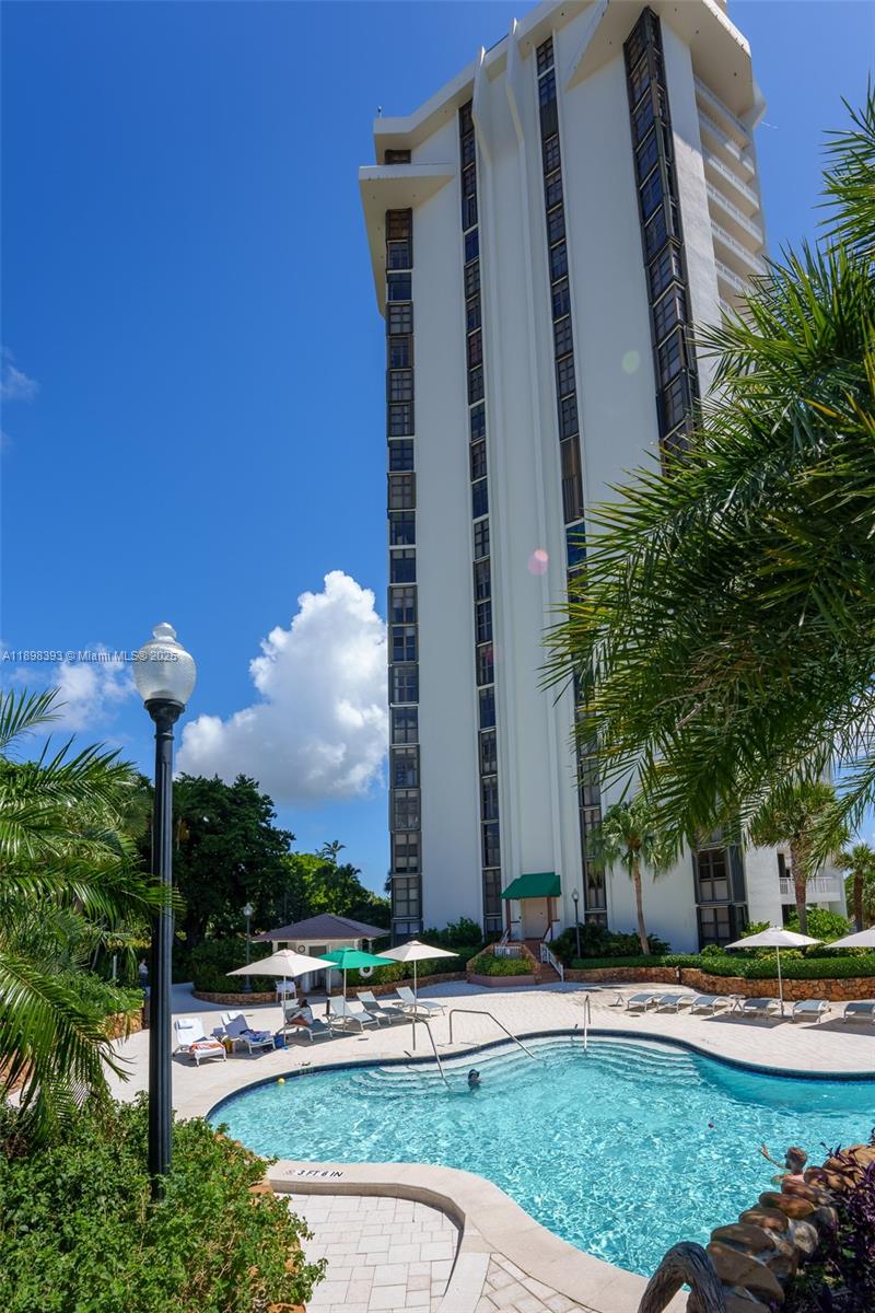 4000 Towerside Terrace, Unit 410 Miami, FL 33138 - Photo 37 of 74 a front view of a building with garden and trees