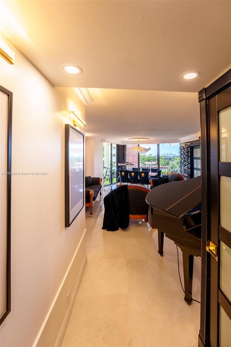 4000 Towerside Terrace, Unit 410 Miami, FL 33138 - Photo 5 of 74 a living room with lots of furniture and a refrigerator