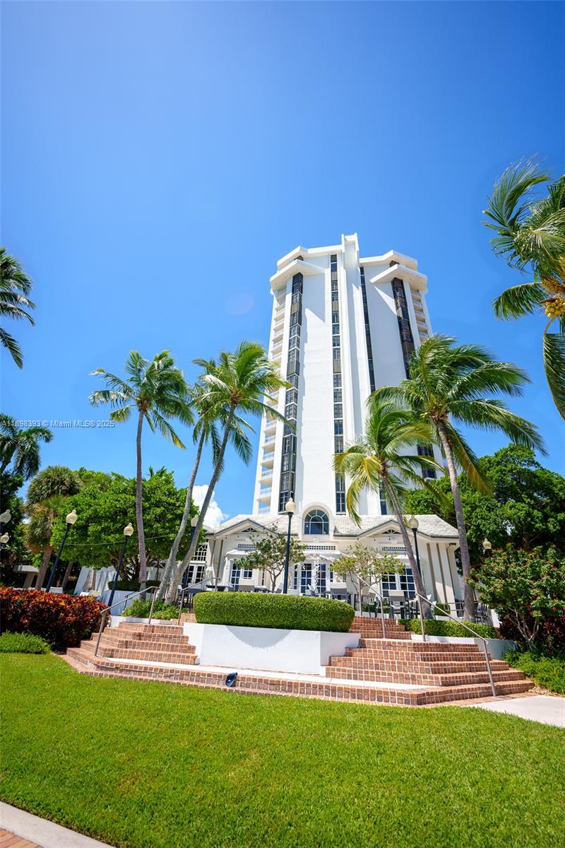 4000 Towerside Terrace, Unit 410 Miami, FL 33138 - Photo 55 of 74 a view of a multi story residential apartment building with a yard