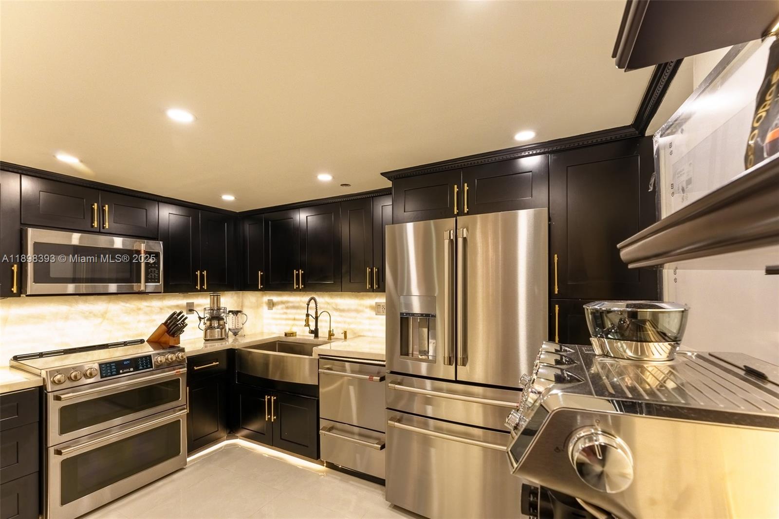 4000 Towerside Terrace, Unit 410 Miami, FL 33138 - Photo 8 of 74 a kitchen with a refrigerator and a stove top oven