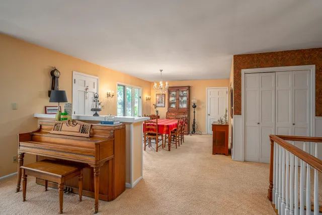 a room with furniture a rug and a window