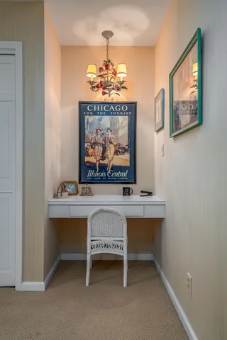 a room with painting on wall and a chandelier