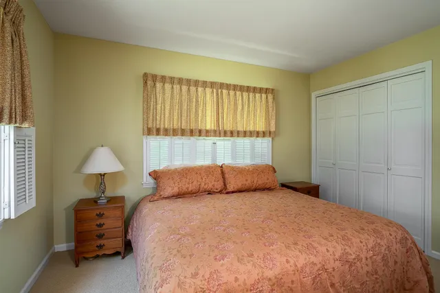 a bedroom with a bed and a lamp