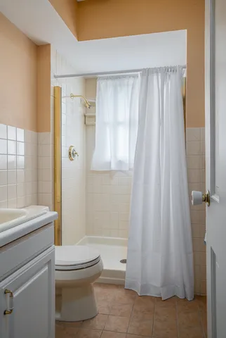 a bathroom with a toilet a sink and a shower