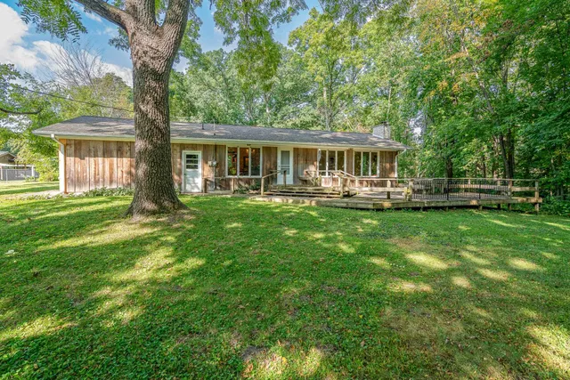 a front view of house with yard and green space