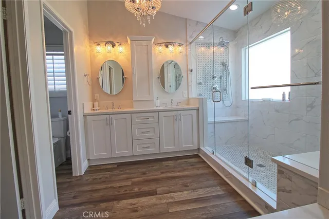 a bathroom with a double vanity sink mirror and shower