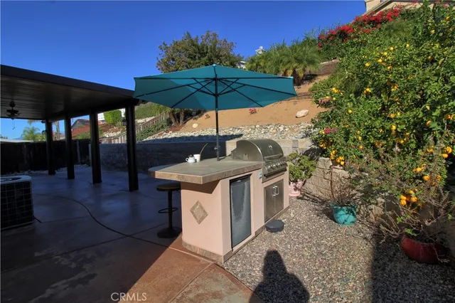 a view of a table and chairs under an umbrella in patio