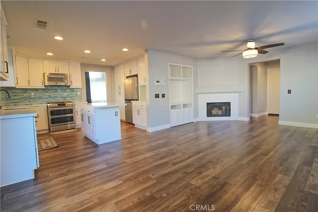 a view of kitchen with cabinets and wooden floor