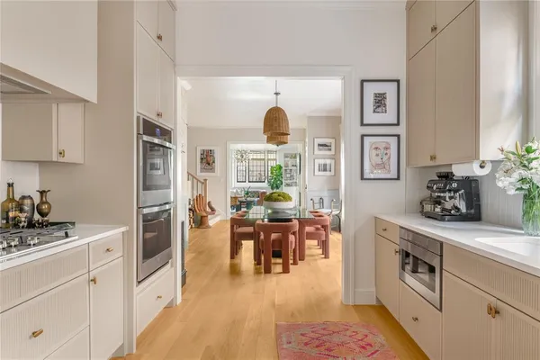 a kitchen with a stove and white cabinets