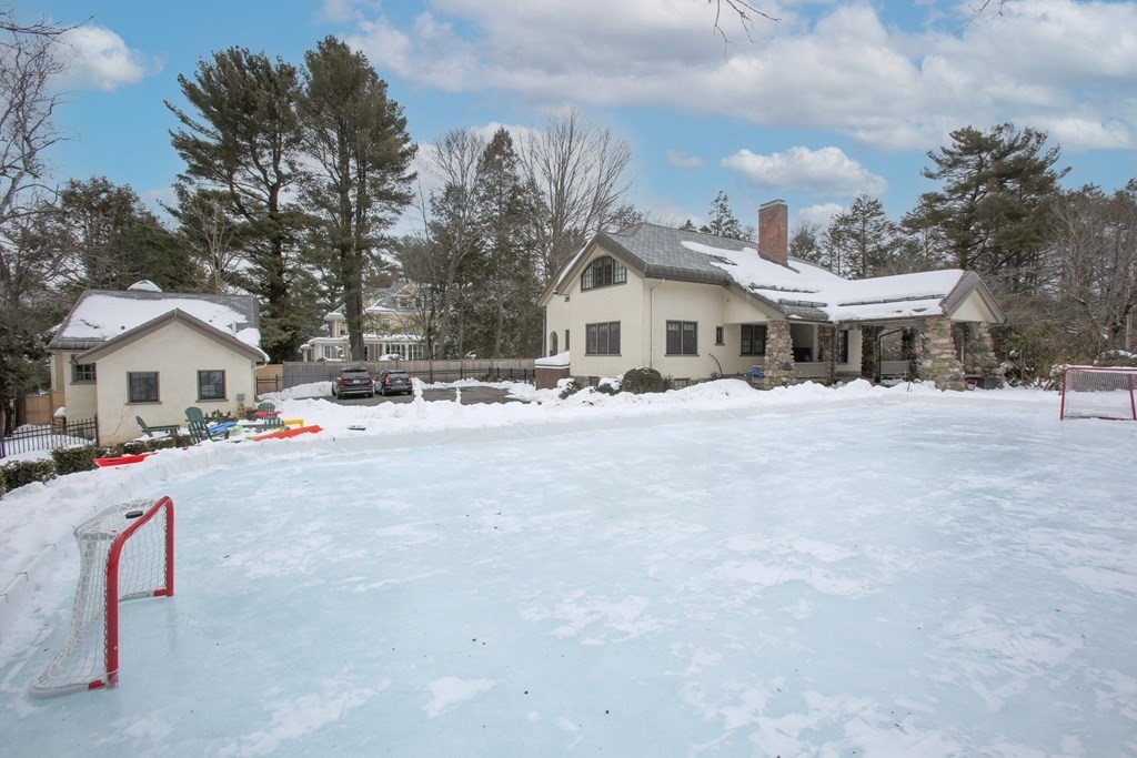 271 Chestnut Street Newton, MA 02465 - Photo 27 of 28 a view of a white house with a yard