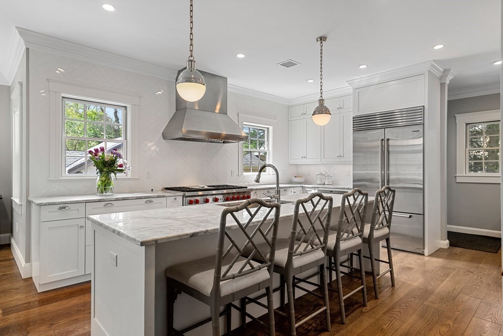 271 Chestnut Street Newton, MA 02465 - Photo 6 of 28 a kitchen with a table chairs stove and wooden floor