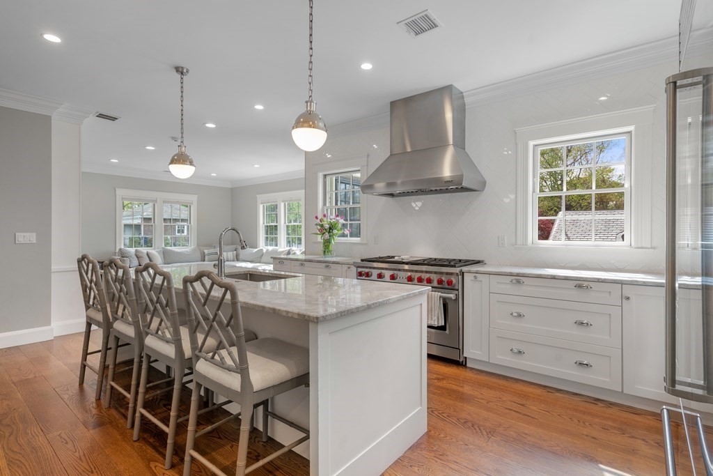 271 Chestnut Street Newton, MA 02465 - Photo 7 of 28 a kitchen with stainless steel appliances granite countertop a stove a refrigerator and wooden cabinets