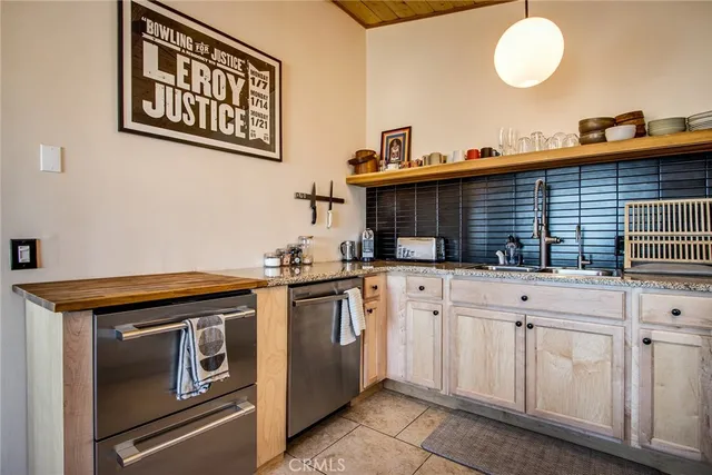 a kitchen with granite countertop a sink and a stove