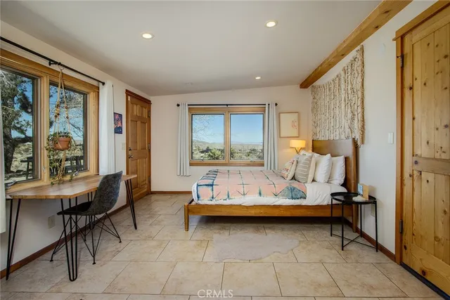 a bedroom with furniture and a window