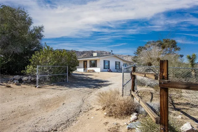 a view of house with wooden fence