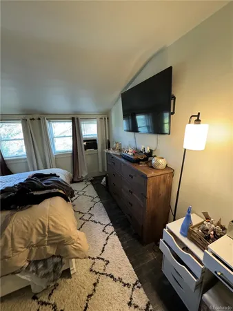 a bedroom with a bed and flat screen tv