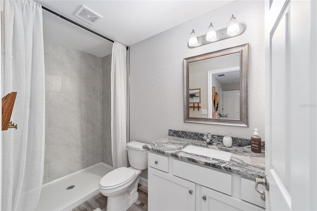 8571 Southwest 131st Place Ocala, FL 34473 - Photo 22 of 32 a bathroom with a granite countertop sink a toilet and a mirror