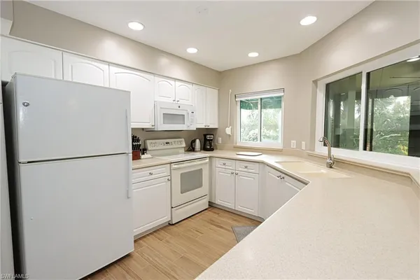 a white refrigerator freezer sitting in a kitchen