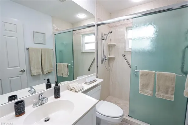 a bathroom with a sink toilet and shower