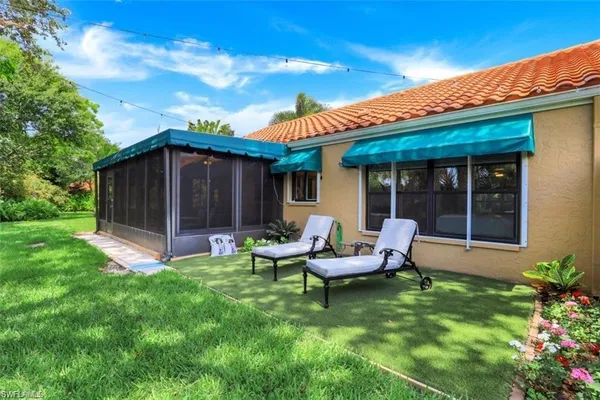 a view of a house with backyard sitting area and garden
