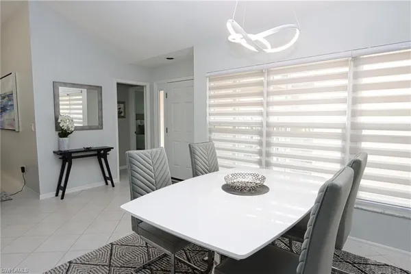 a view of a dining room with furniture and window