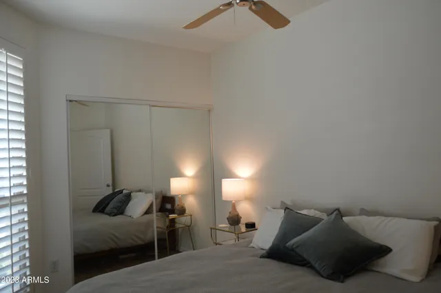 a bathroom with a granite countertop sink toilet and a mirror