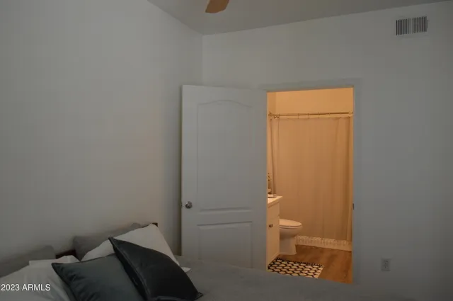 a bathroom with a sink a toilet and mirror