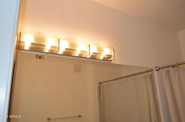 a view of a workspace with furniture and a bathroom