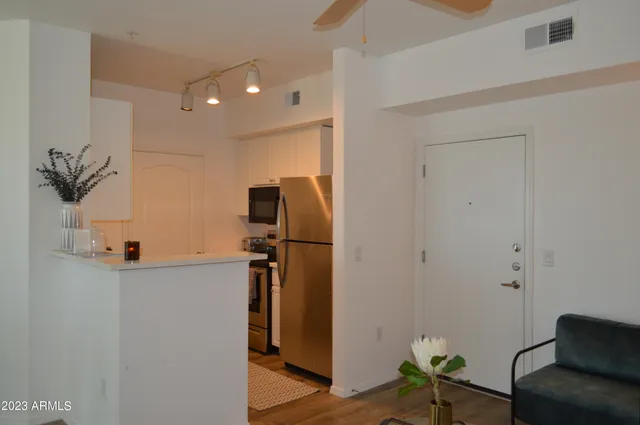 a view of a hallway with workspace and a window