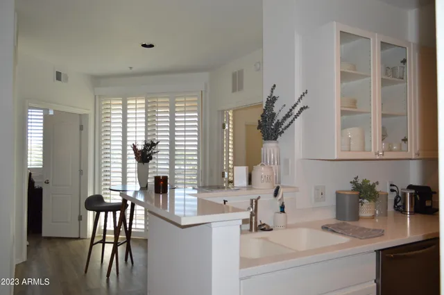 a bathroom with a granite countertop sink and a window
