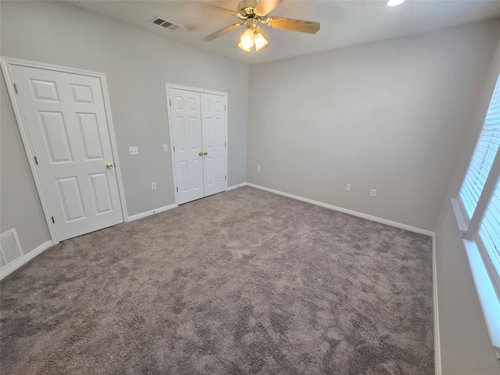 7509 Lazy Creek Drive, Unit B Austin, TX 78724 - Photo 12 of 20 Unfurnished bedroom featuring carpet flooring, a ceiling fan, a closet, and recessed lighting
