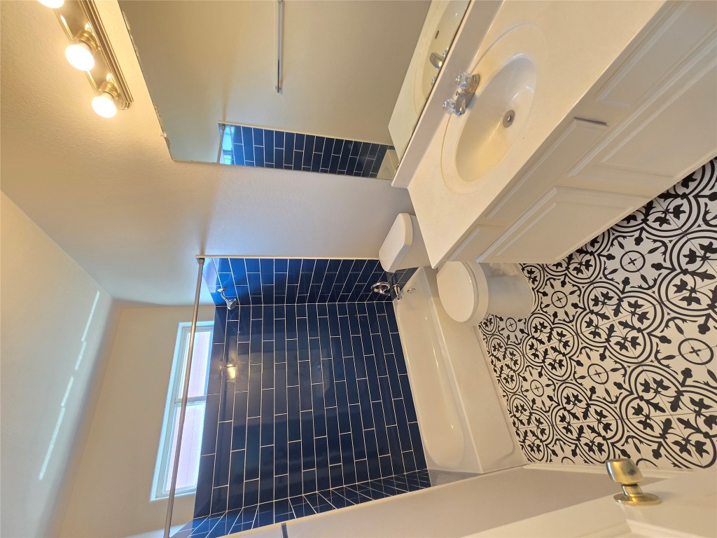 7509 Lazy Creek Drive, Unit B Austin, TX 78724 - Photo 14 of 20 Bathroom with washtub / shower combination, vanity, and tile patterned floors