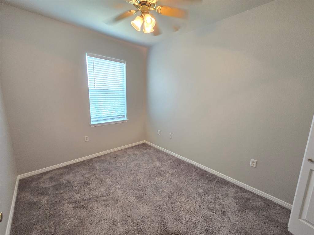 7509 Lazy Creek Drive, Unit B Austin, TX 78724 - Photo 15 of 20 Carpeted spare room with baseboards and ceiling fan