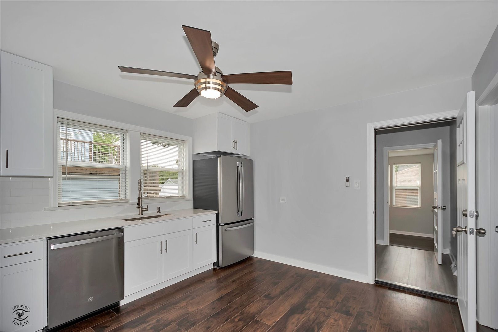 7229 57th Place Summit, IL 60501 - Photo 11 of 30 a kitchen with stainless steel appliances a refrigerator sink and white cabinets