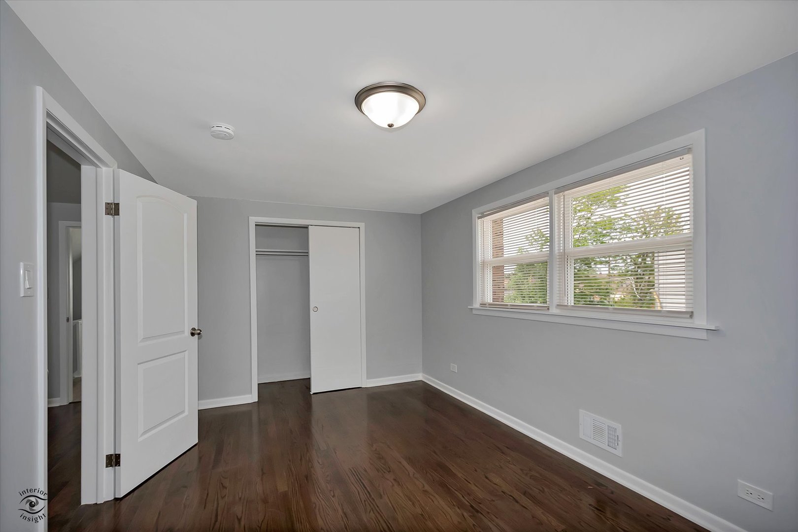 7229 57th Place Summit, IL 60501 - Photo 18 of 30 a view of an empty room with wooden floor and a window