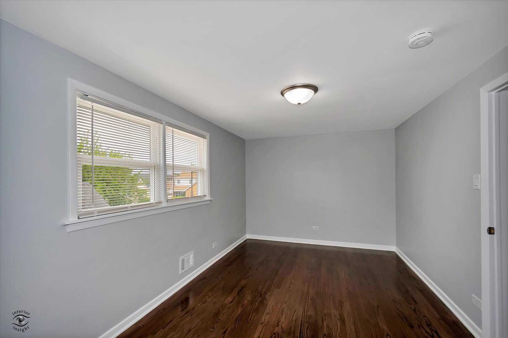 7229 57th Place Summit, IL 60501 - Photo 19 of 30 a view of an empty room with wooden floor and a window