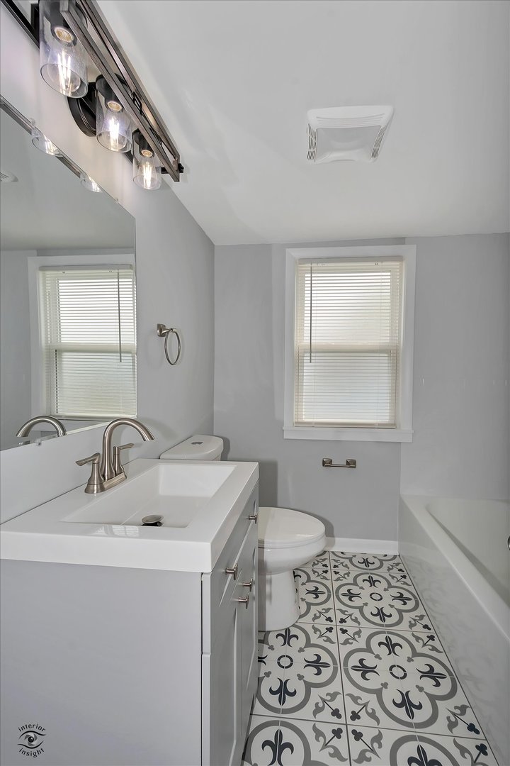 7229 57th Place Summit, IL 60501 - Photo 20 of 30 a bathroom with a sink a toilet and a mirror