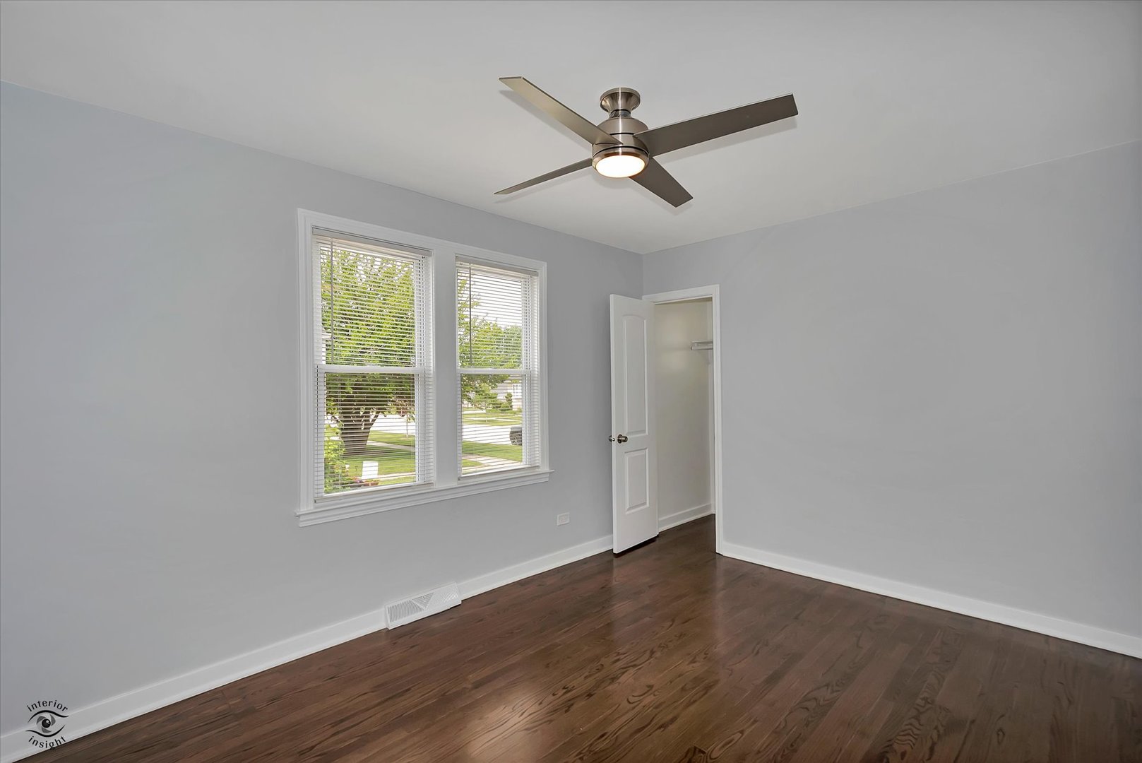7229 57th Place Summit, IL 60501 - Photo 23 of 30 a view of a big room with wooden floor closet and windows