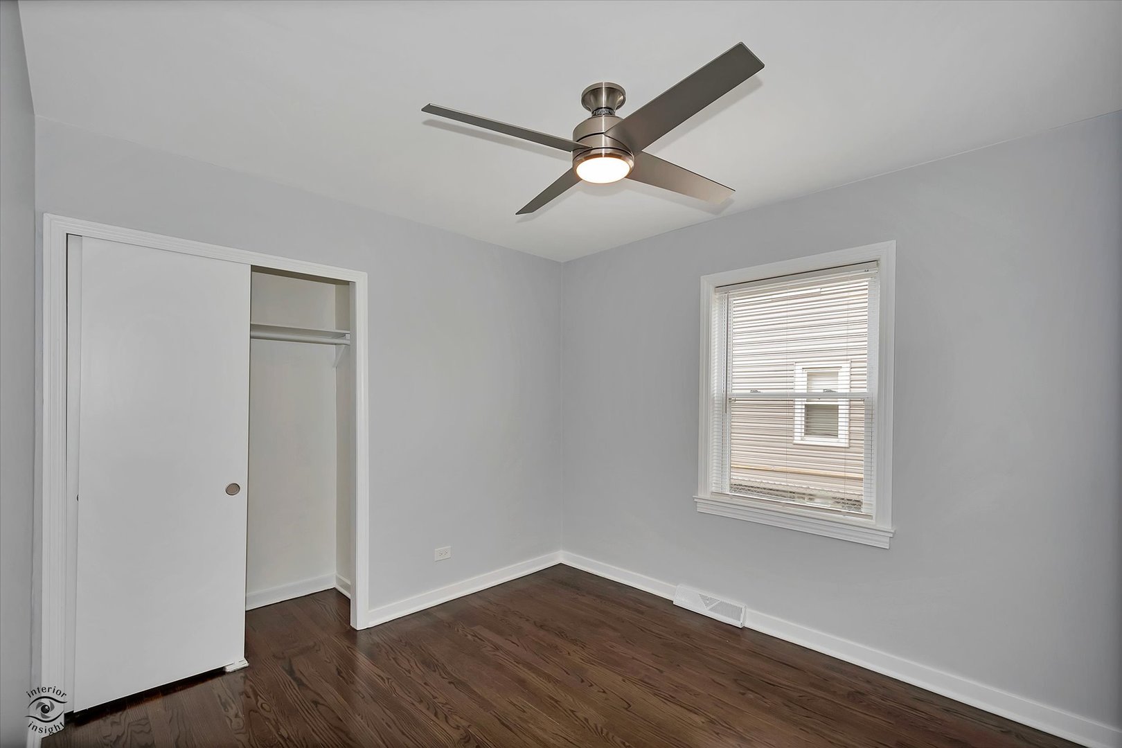7229 57th Place Summit, IL 60501 - Photo 24 of 30 an empty room with wooden floor fan and windows