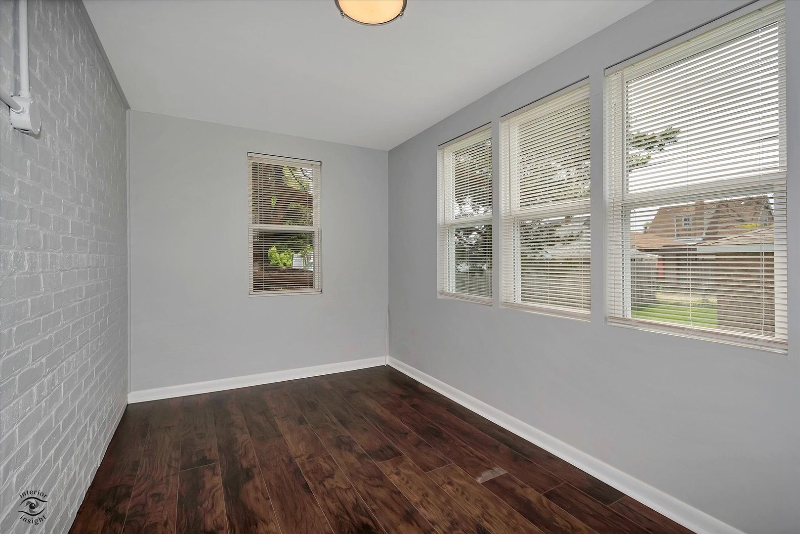 7229 57th Place Summit, IL 60501 - Photo 25 of 30 a view of an empty room with wooden floor and a window