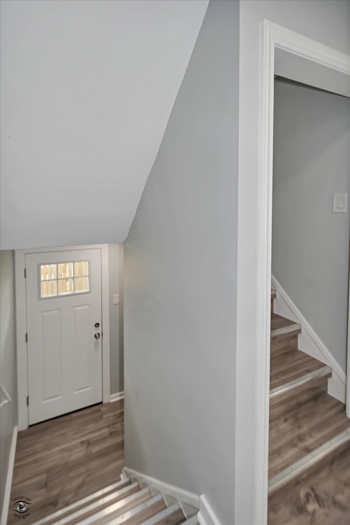 7229 57th Place Summit, IL 60501 - Photo 28 of 30 a view of a hallway with wooden floor and staircase