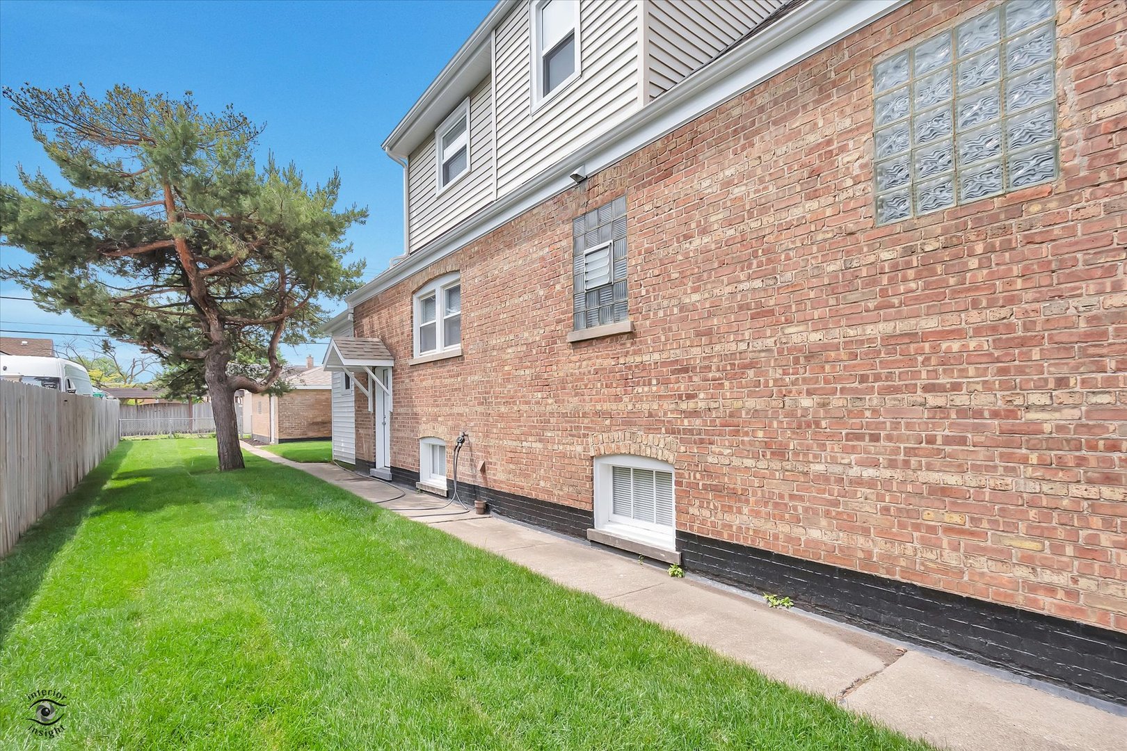 7229 57th Place Summit, IL 60501 - Photo 3 of 30 a view of a backyard with plants and large trees