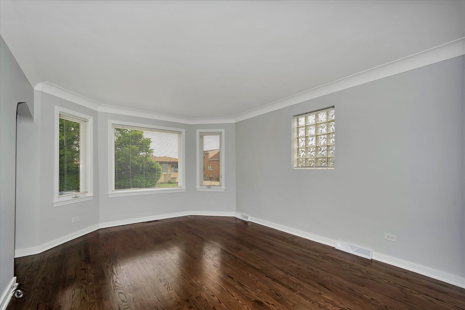 7229 57th Place Summit, IL 60501 - Photo 8 of 30 a view of an empty room with wooden floor and a window