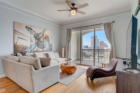 a living room with furniture and a floor to ceiling window