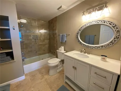 a view of a patio with a table chairs and a swimming pool