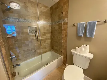 a view of a house with swimming pool and sitting area