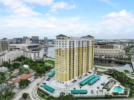a living room with furniture stove and large window
