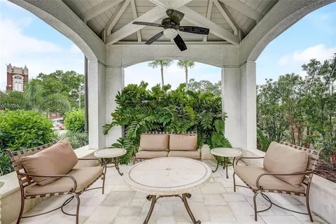 a room with gym equipment and glass door shower