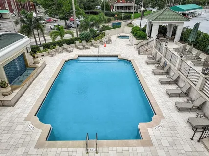 a view of swimming pool with outdoor seating and plants